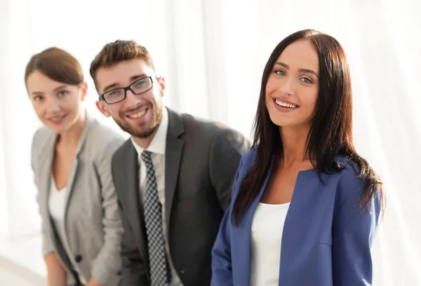 Young business woman smiling with her colleagues in the backgrou — Stock Photo, Image