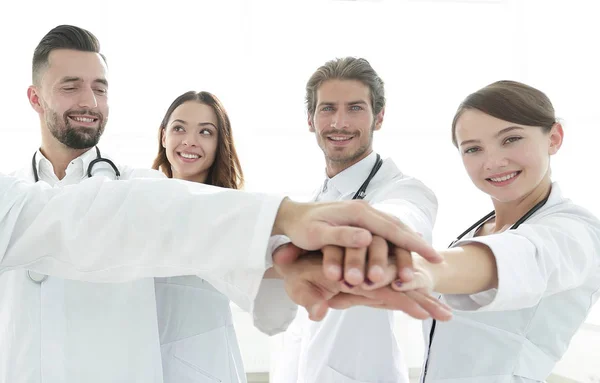 Doctors and nurses in a medical team stacking hands — Stock Photo, Image