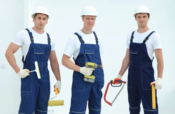 team of construction workers with working tools