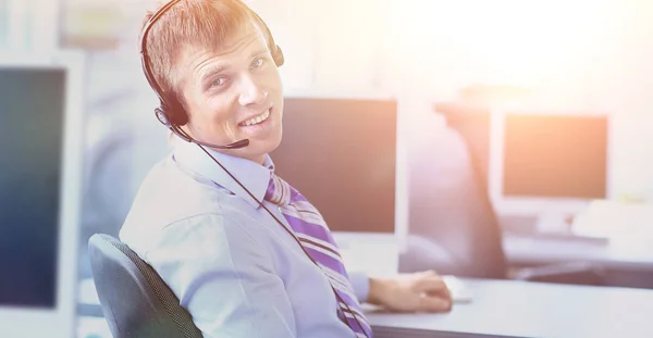 Gelukkig jonge man werken bij callcenter, via headset — Stockfoto