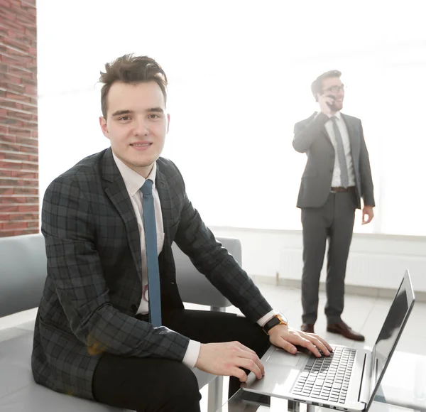 Jeune homme d'affaires travaillant avec un ordinateur portable au bureau — Photo