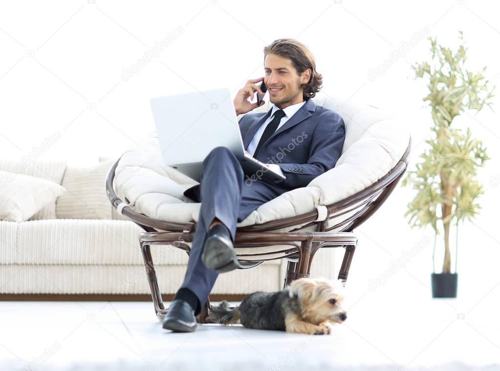 business man talking on a smartphone sitting in the living room