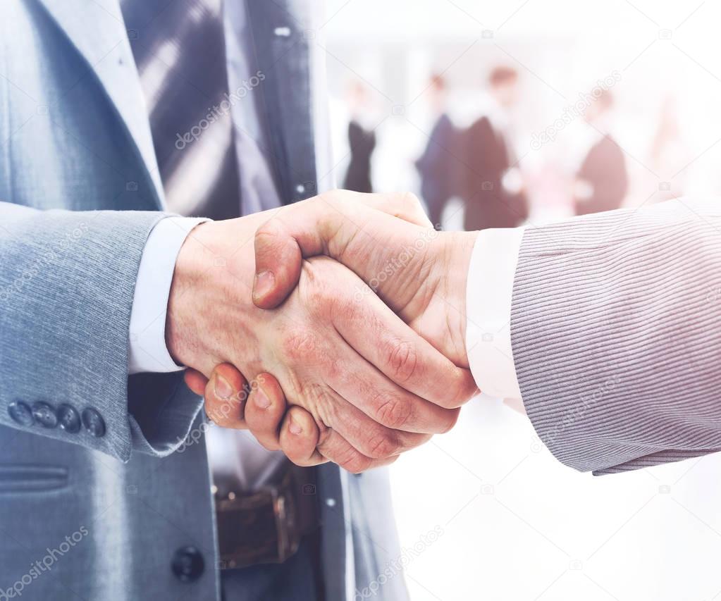 Closeup of handshake as a sign of successful cooperation and int