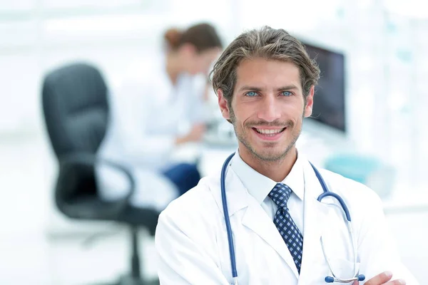 Jóképű férfi orvos mosolyog karokkal keresztbe tett mellkason portré — Stock Fotó