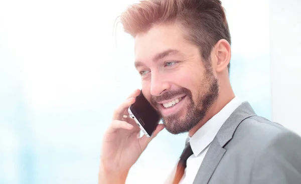 Handsome Business man in an office using smartphone