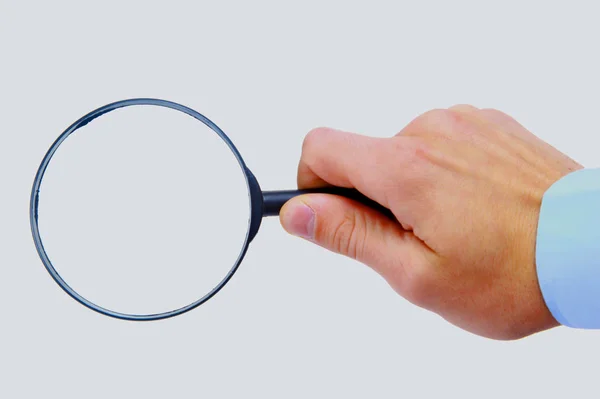 Magnifying glass in hand — Stock Photo, Image