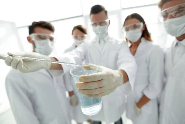 Closeup of a group of medical workers working with liquids — Stock Photo, Image