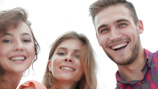 Primer plano de tres jóvenes sonriendo sobre fondo blanco —  Fotos de Stock