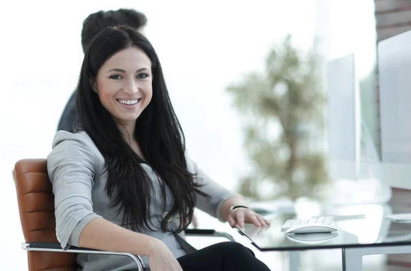 Succesvolle glimlachende zakenvrouw aan het bureau — Stockfoto