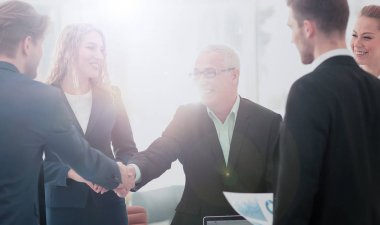 Ortağı ile bir anlaşma imzalamaya tokalaşırken olgun iş adamı