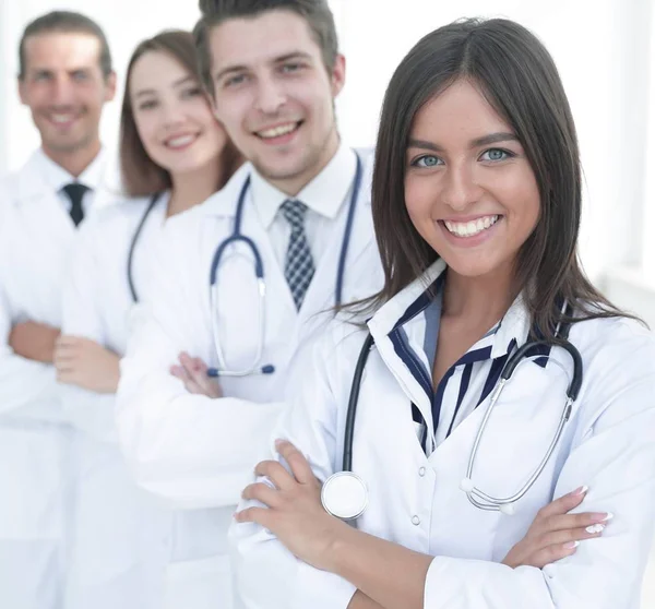 Female doctor with group of happy successful colleagues — Stock Photo, Image