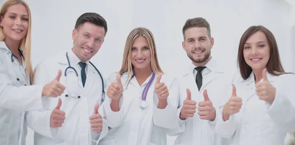 Portrait of happy doctors team showing thumbs up — Stock Photo, Image