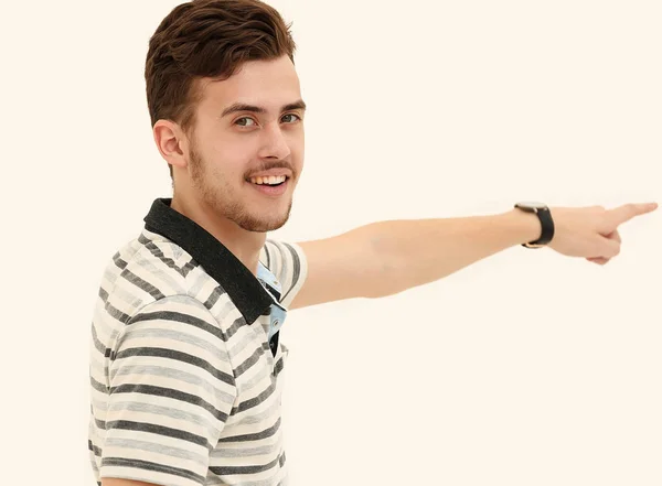 Side view.modern young man pointing forward and looking at the camera. — Stock Photo, Image