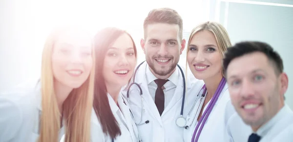 Smiling team of doctors at hospital making selfie. — Stock Photo, Image