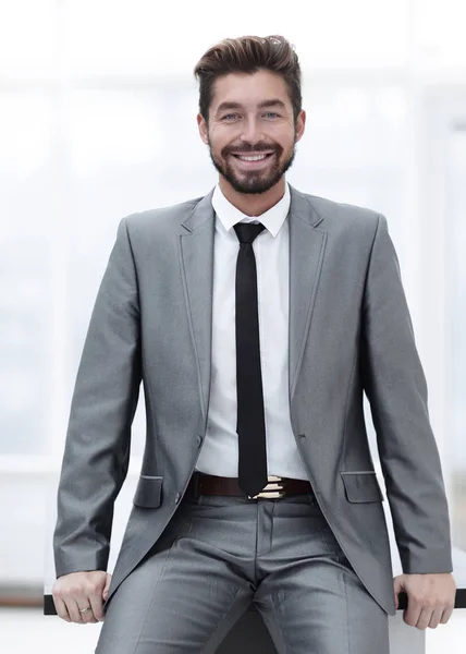 Portrait of a young businessman at the railing in the office — Stock Photo, Image