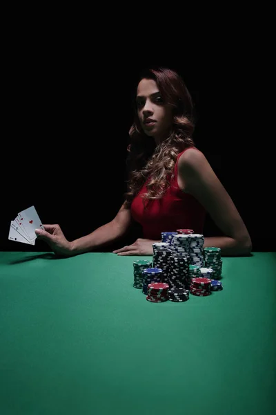 Pretty young woman gambling on green table — Stock Photo, Image