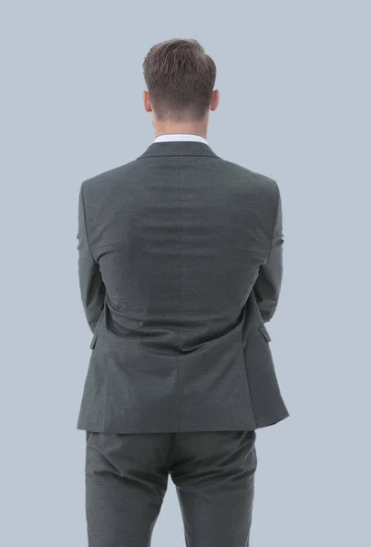 Businessman from the back - looking at something over a gray bac — Stock Photo, Image
