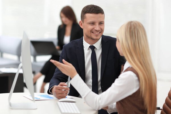 Manager talking with a colleague at the workplace