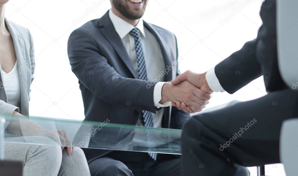 handshake business partners in the office