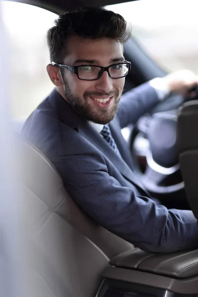 Man in formalwear sitting in car — Stock Photo, Image