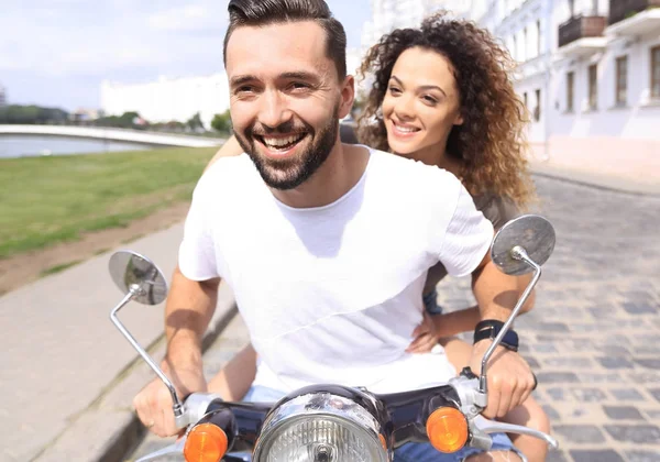 Feliz pareja alegre montando scooter vintage al aire libre . — Foto de Stock