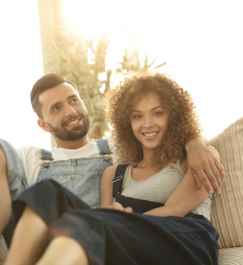 Genç çift kanepede oturan iş elbiseleri