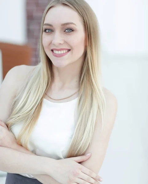 Close-up portrait of a young woman on a blurred office background. — Stock Photo, Image