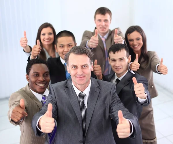 Happy business team holding thumbs up — Stock Photo, Image