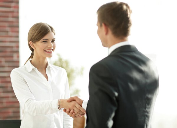 handshake young business woman with a colleague