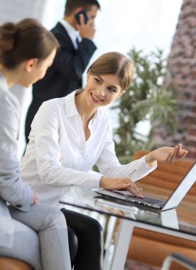 Yöneticisi ve istemci laptop ile alınan bilgi tartışıyorlar