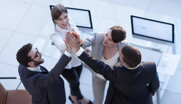 Successful business team giving each other a high-five, standing in the office — Stock Photo, Image