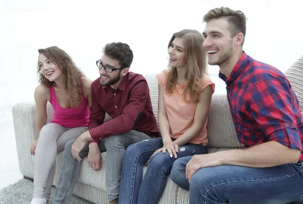 Group of smiling young people sitting on the couch — Stock Photo, Image