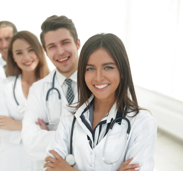 Female doctor with group of happy successful colleagues — Stock Photo, Image