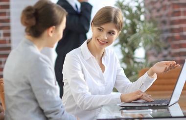 Yöneticisi ve istemci laptop ile alınan bilgi tartışıyorlar