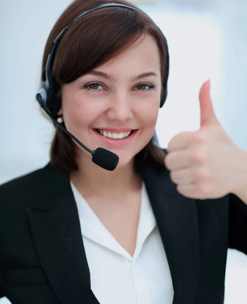 Krásná žena pracující v callcenter, pomocí sluchátek s mikrofonem ukazuje Čt — Stock fotografie