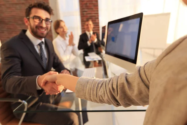 パソコンのそばに座ってビジネス パートナーと握手するビジネスマン — ストック写真
