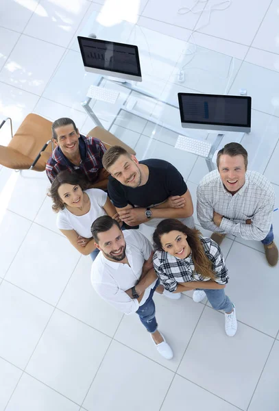 Young professionals standing near the desktop — Stock Photo, Image