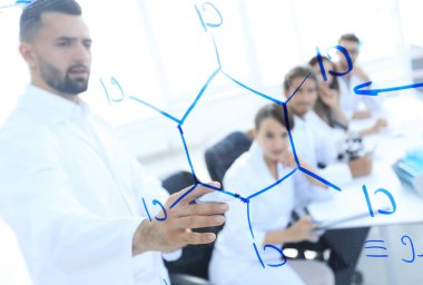 Camın arkasından. Laboratuarda blackboard yakın duran bir bilim adamı.