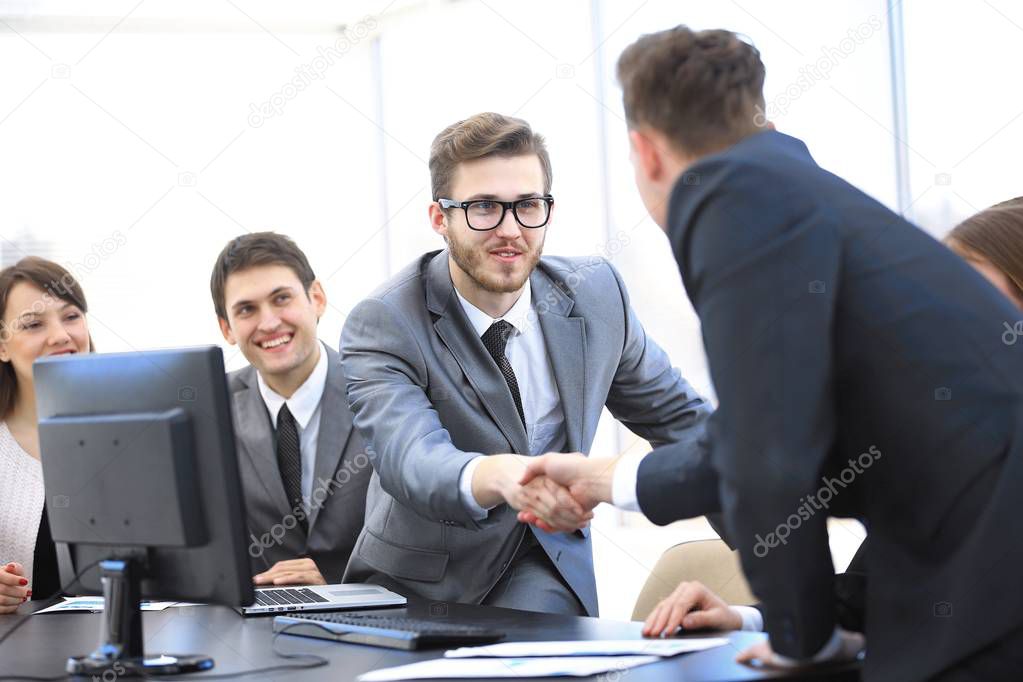 handshake business partners at a business meeting