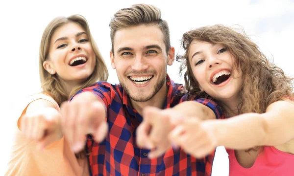 Closeup tři šťastné mladých lidí ukazuje rukou vpřed — Stock fotografie