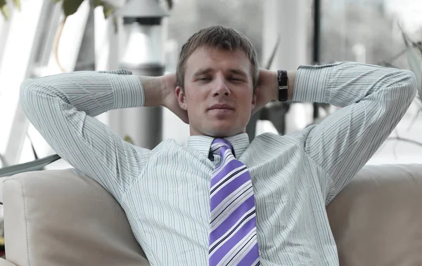 Serious handsome businessman relaxing in the lobby — Stock Photo, Image