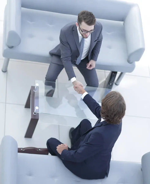 Colleagues shaking hands in office — Stock Photo, Image