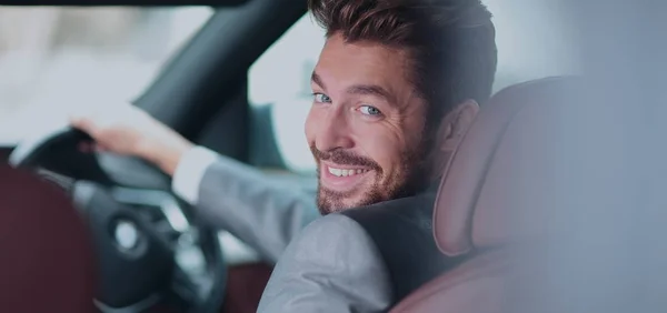 Portrait of an handsome smiling business man driving his car — Stock Photo, Image