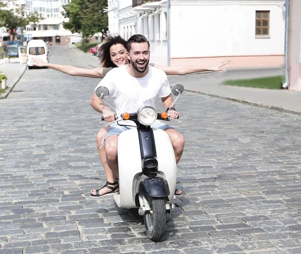 Glückliches junges Paar, das Spaß auf einem Roller hat — Stockfoto