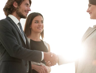 İş adamları geniş pencereli odaya karşı el sıkışıyor