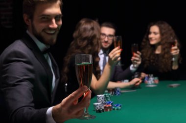 poker oyuncusu bir kadeh şarap ile