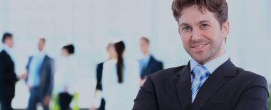 ofisinde memnuniyeti ile kameraya bakarak mutlu olgun iş adamı