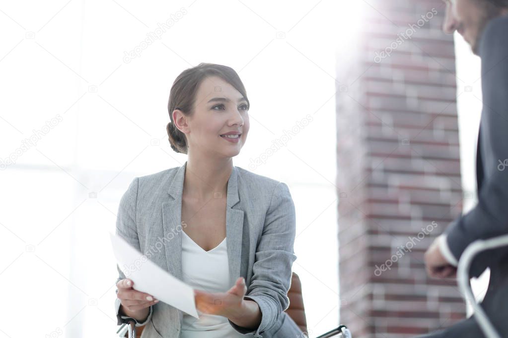 A relaxed conversation of a man and a woman in the office