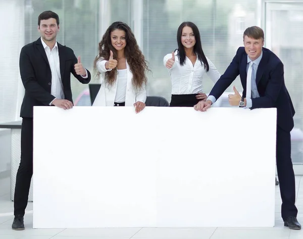 Business team holding blank white banner — Stock Photo, Image