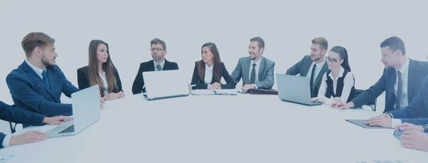 Business partners with documents and laptops sitting around the — Stock Photo, Image